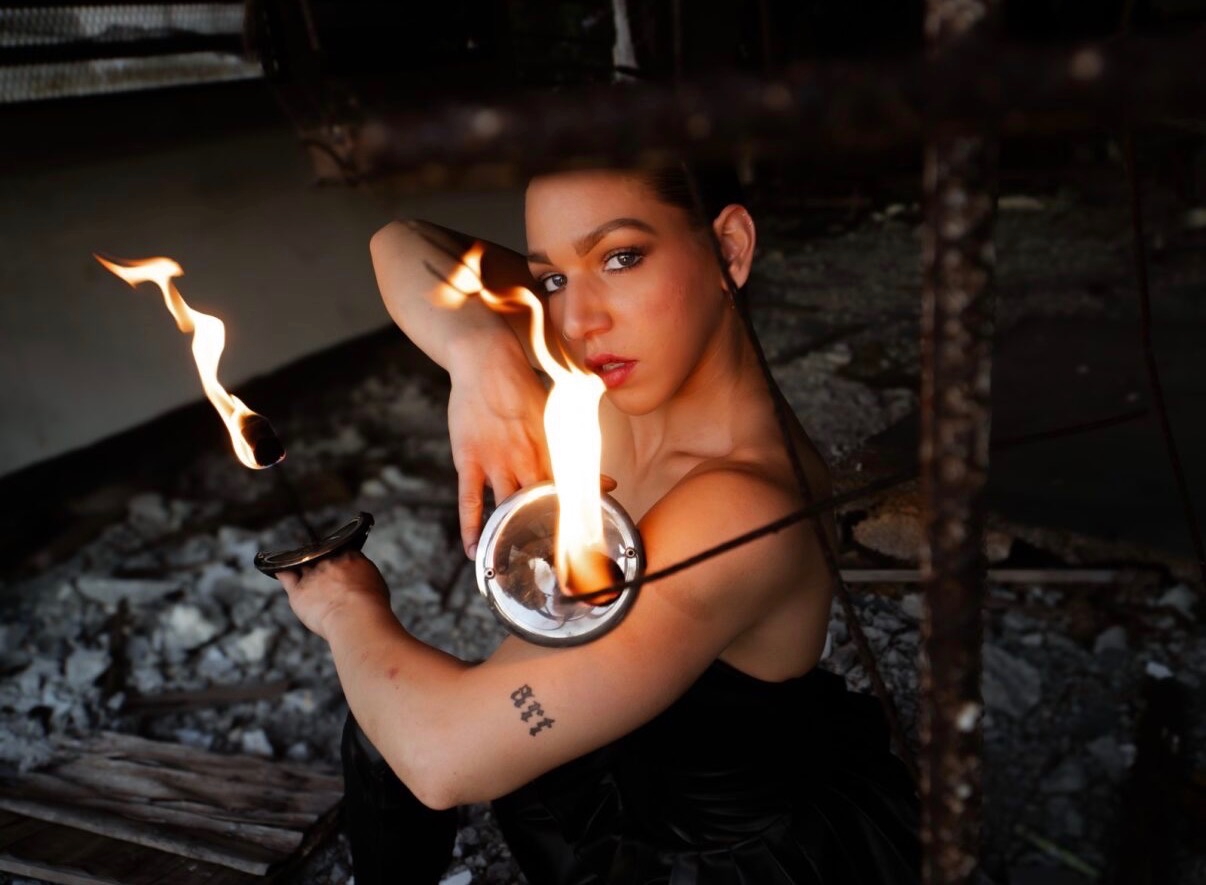 Daisy with fire poi close-up portrait