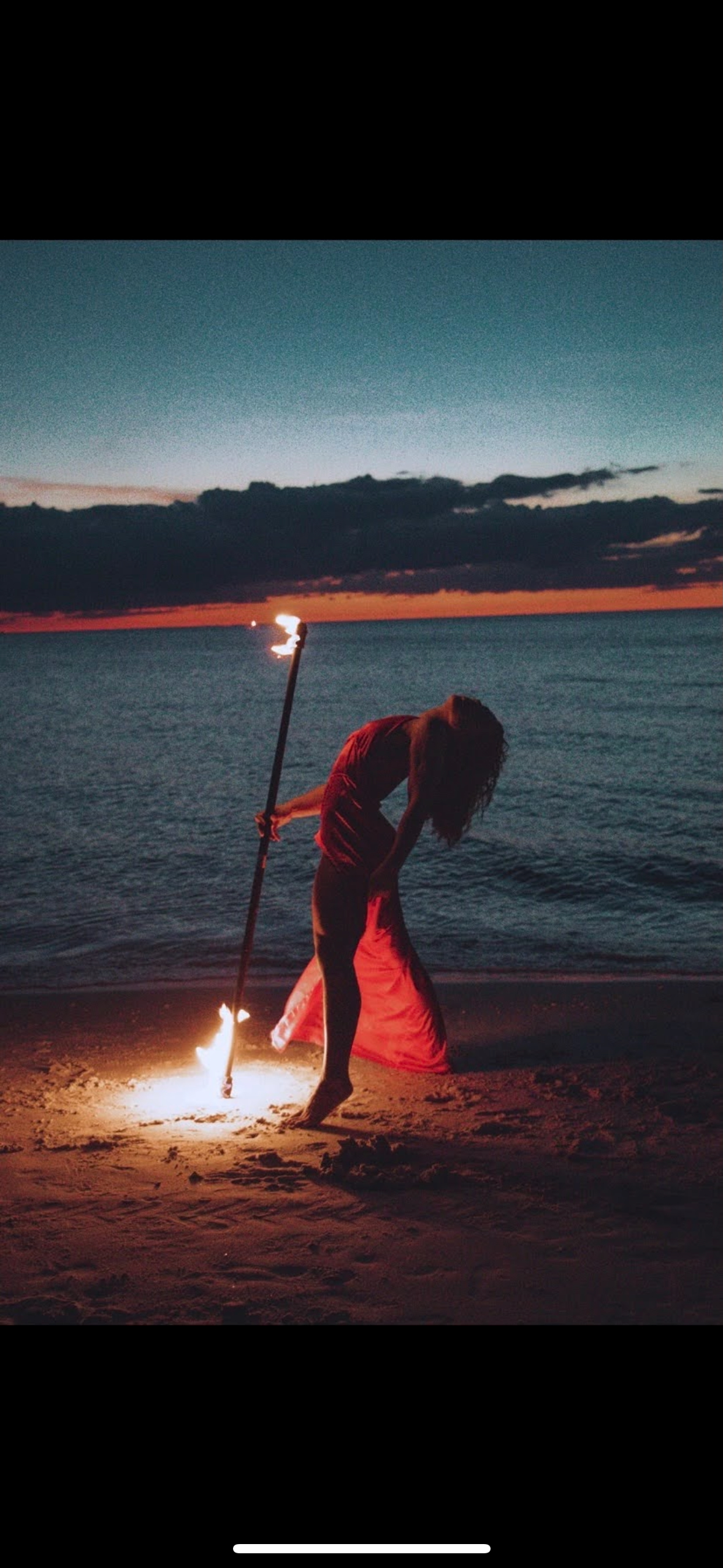 Fire staff on the beach at sunset
